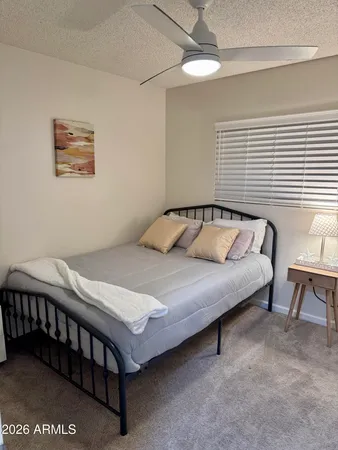 a bedroom with a bed and lamps