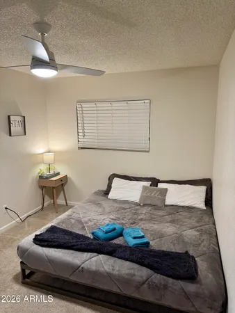 a bedroom with a bed and lamp