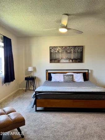 a bedroom with a bed and a television