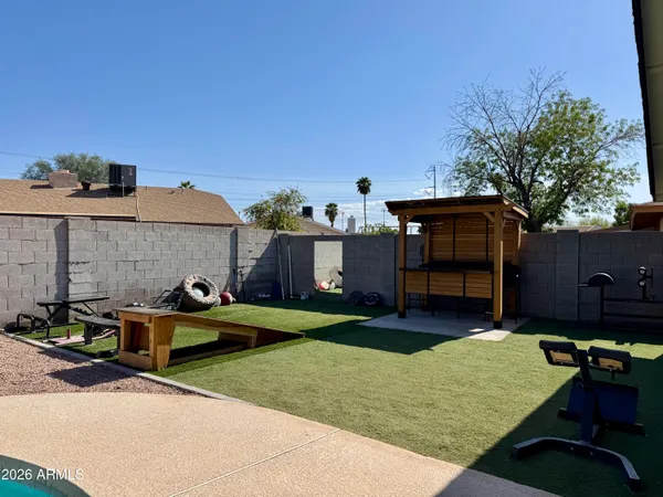 a view of a house with backyard and patio