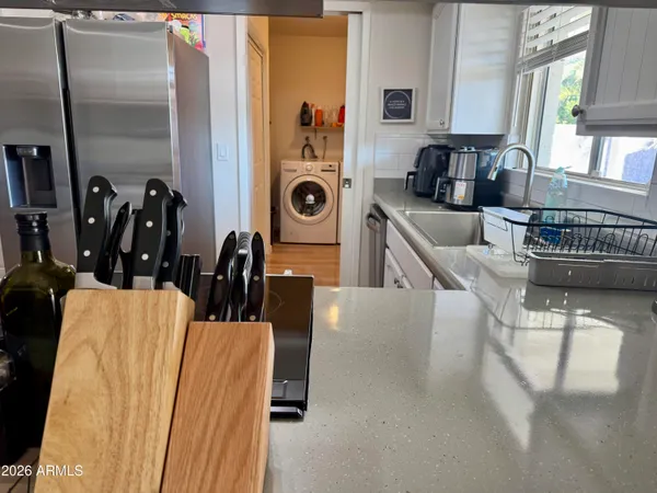 a kitchen with stainless steel appliances a sink a stove a refrigerator and cabinets