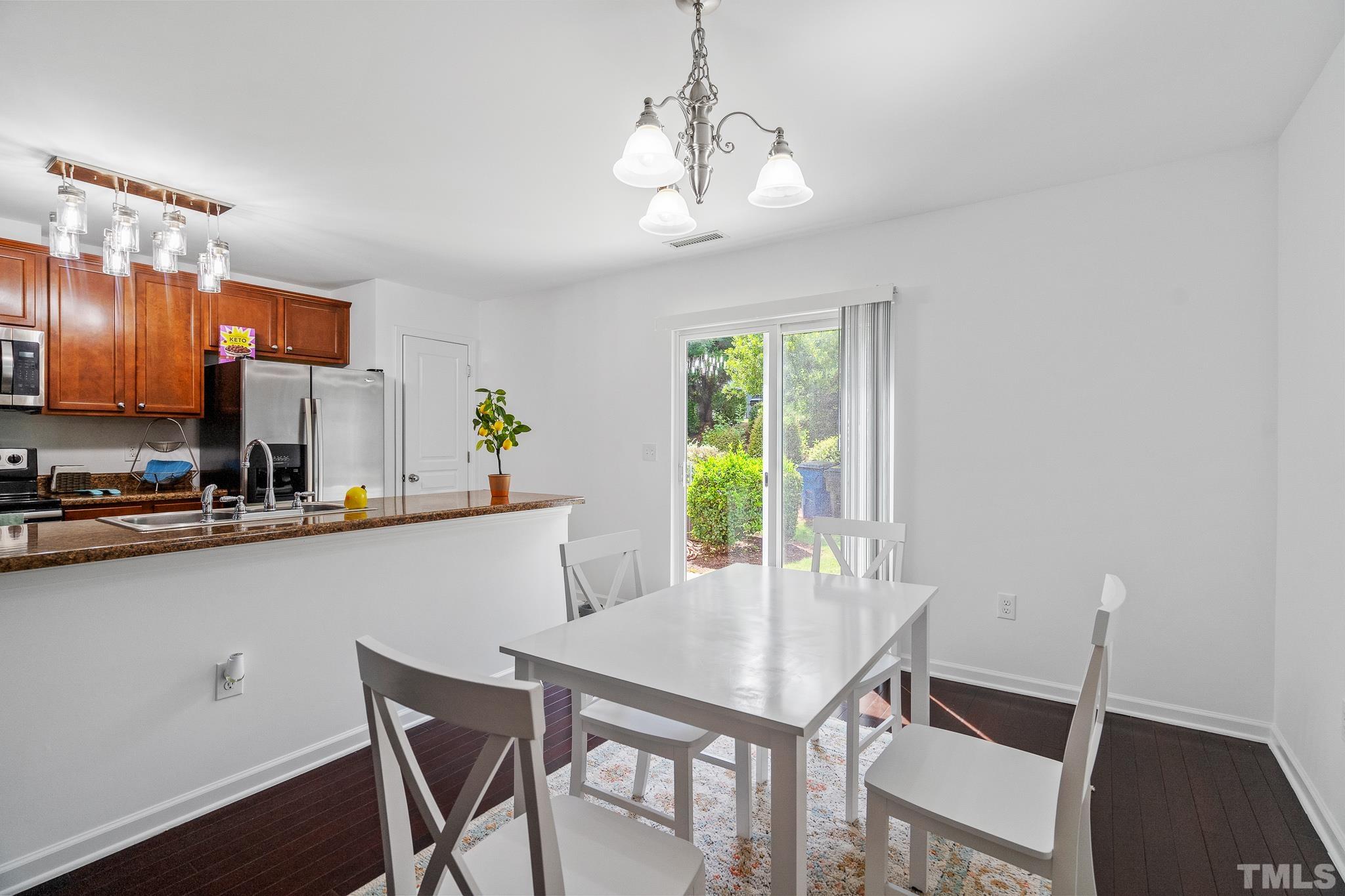 2931 Berkeley Springs Place Raleigh, NC 27616 - Photo 11 of 32 a view of a dining room with furniture and a chandelier