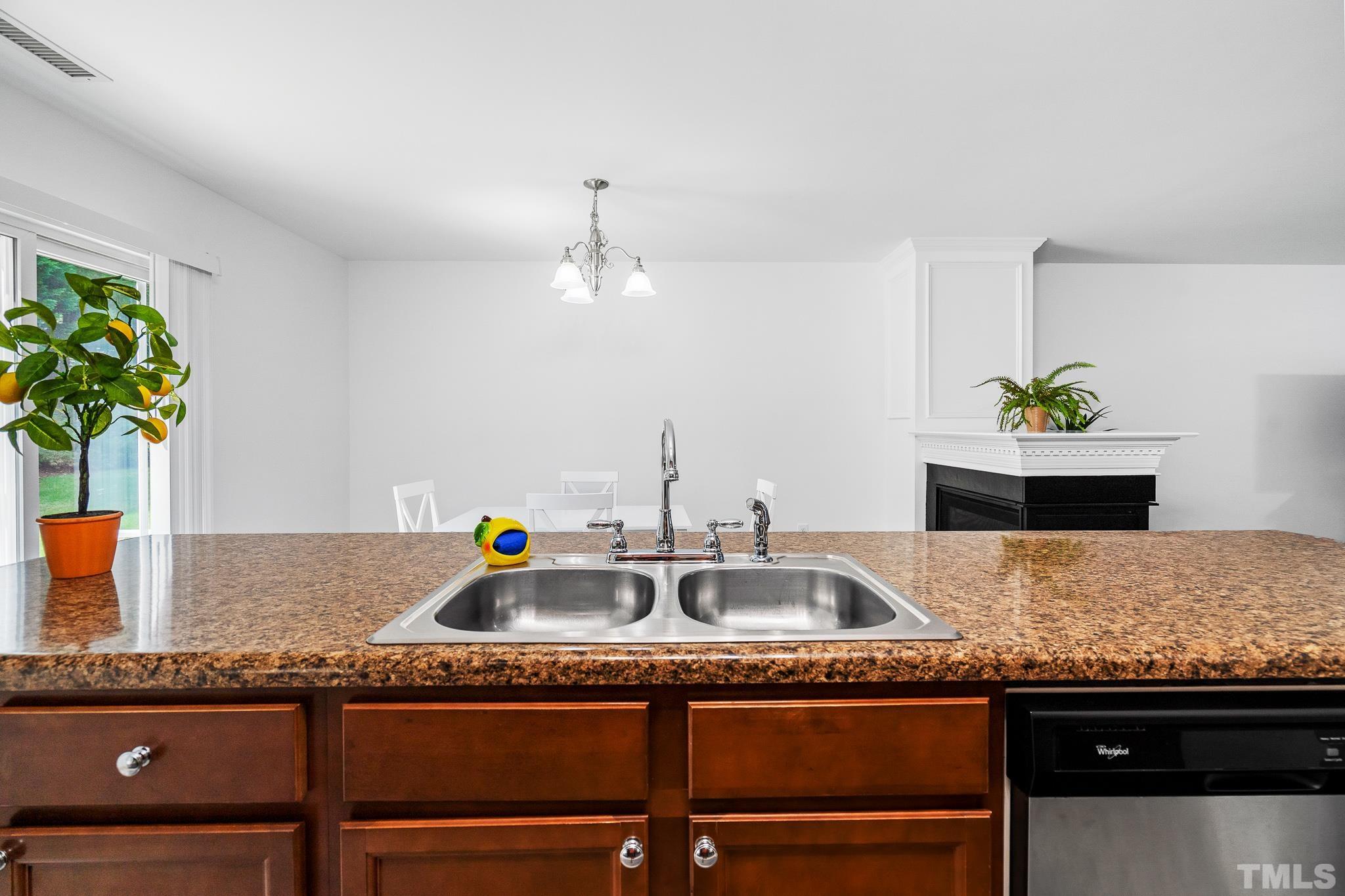 2931 Berkeley Springs Place Raleigh, NC 27616 - Photo 20 of 32 a kitchen with granite countertop a sink and a stove
