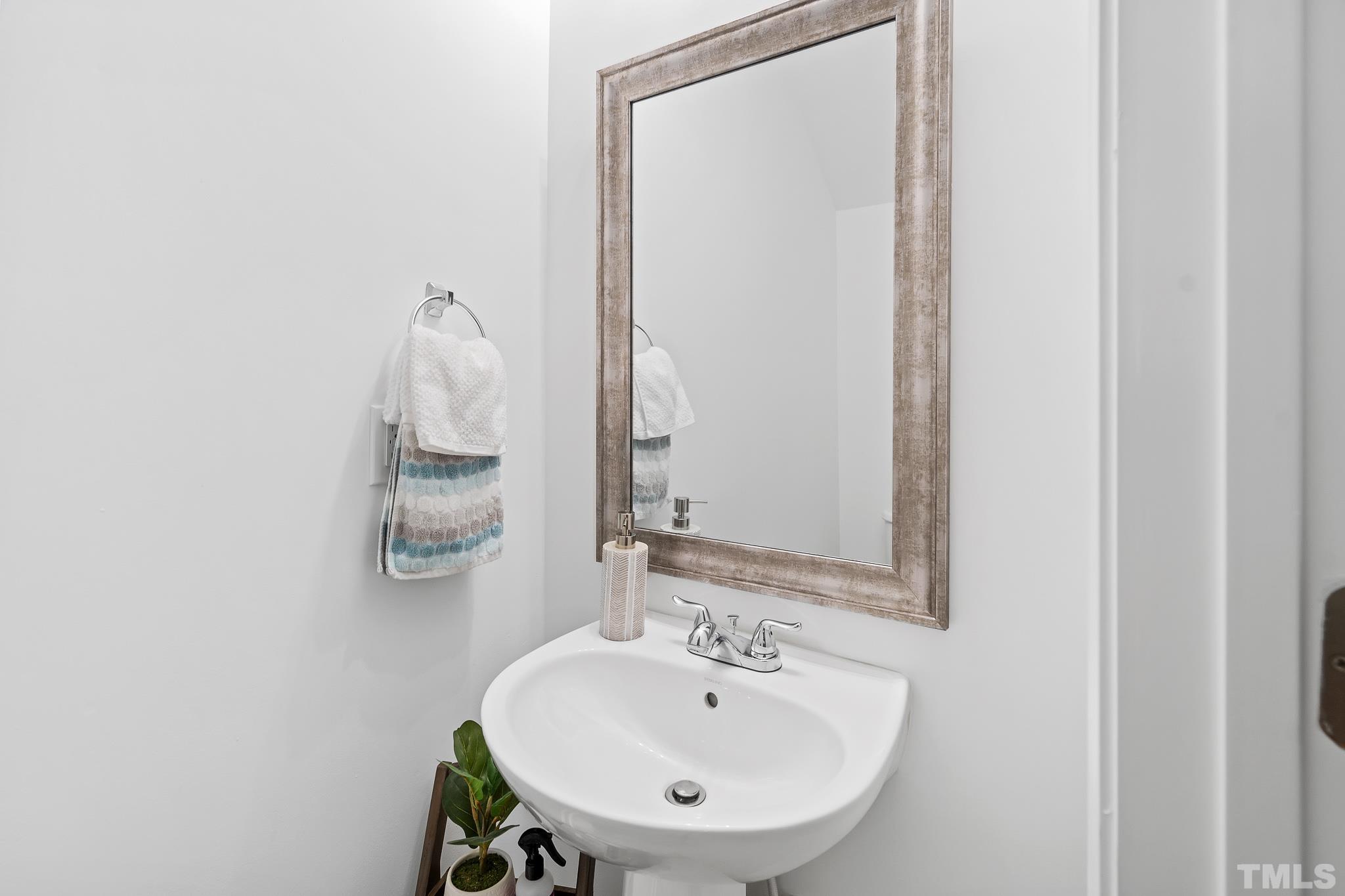 2931 Berkeley Springs Place Raleigh, NC 27616 - Photo 23 of 32 a bathroom with a sink and a mirror