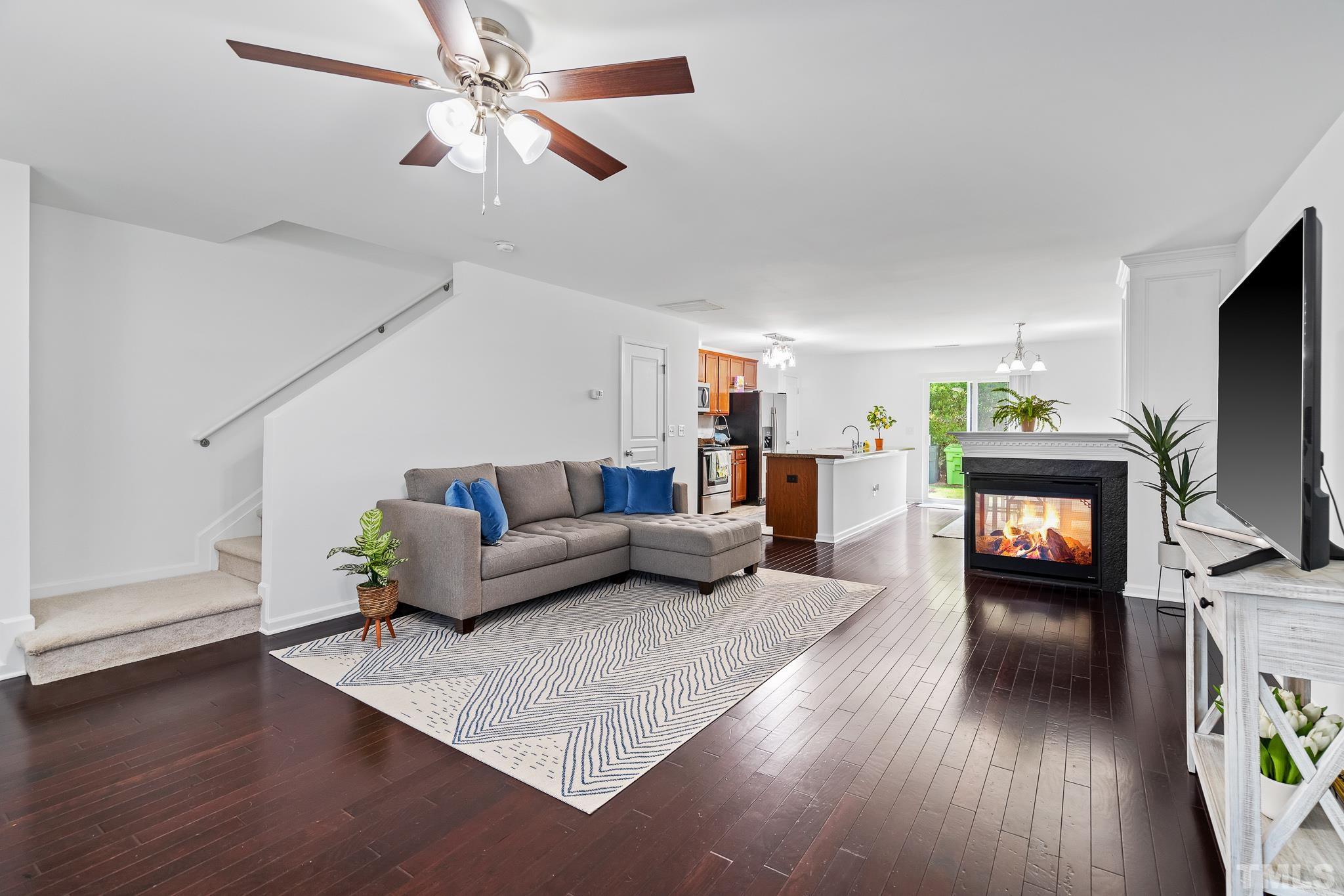 2931 Berkeley Springs Place Raleigh, NC 27616 - Photo 5 of 32 a living room with furniture and a flat screen tv