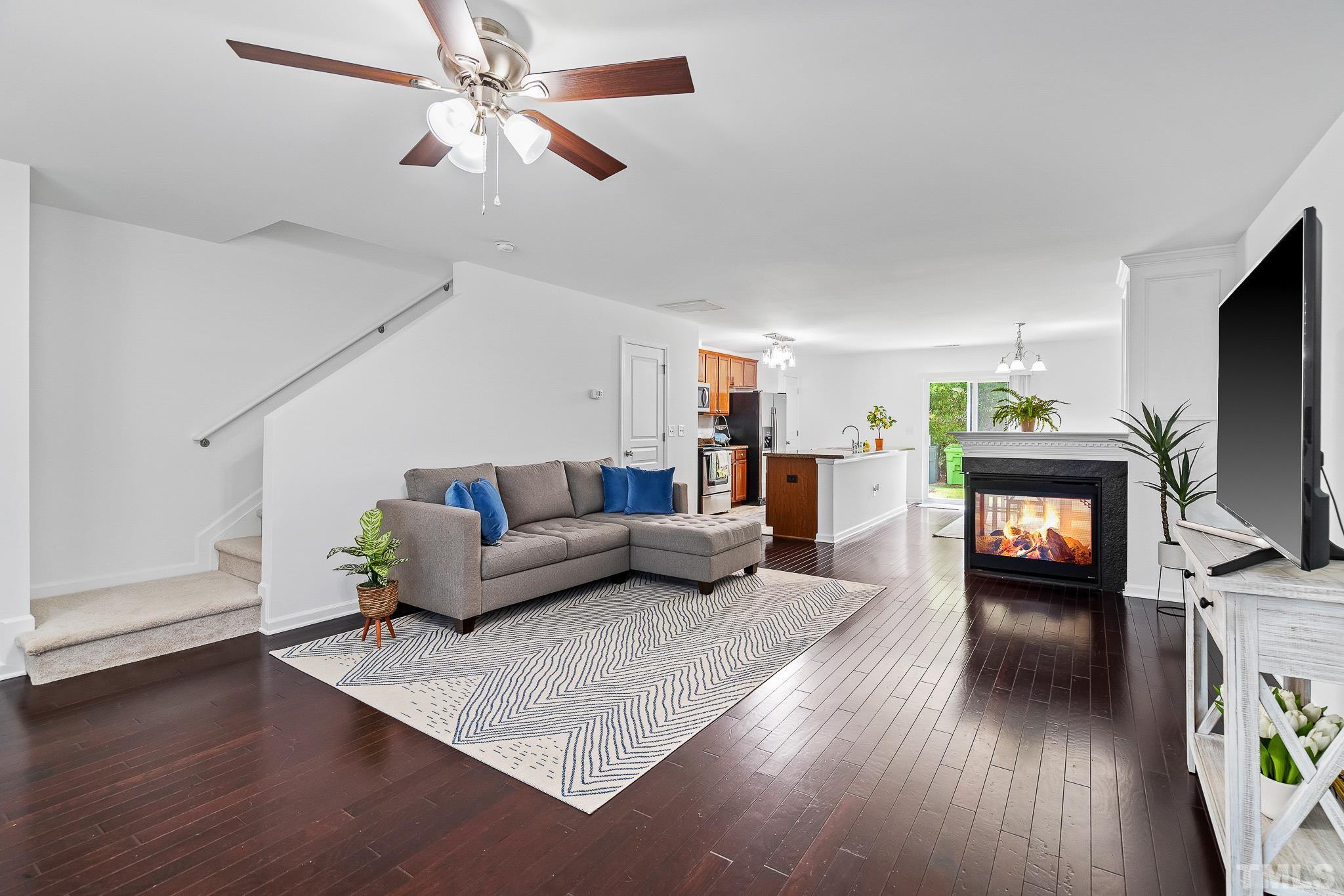 2931 Berkeley Springs Place Raleigh, NC 27616 - Photo 6 of 32 a living room with furniture and a flat screen tv