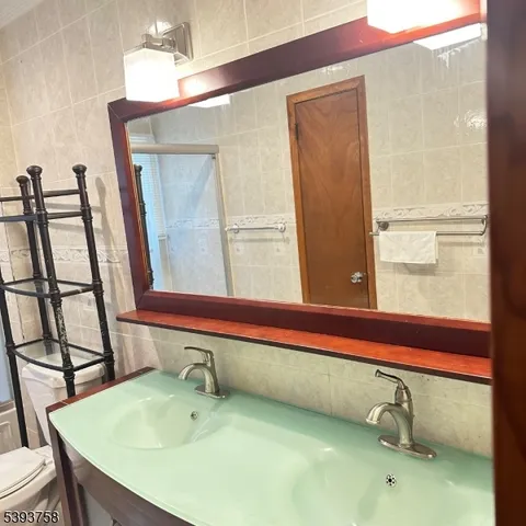 a bathroom with a sink a mirror and a window