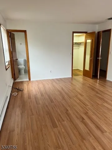 a view of a room with wooden floor and stairs