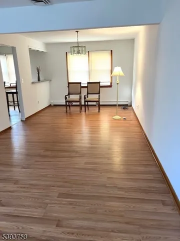 a view of dining room with furniture and wooden floor