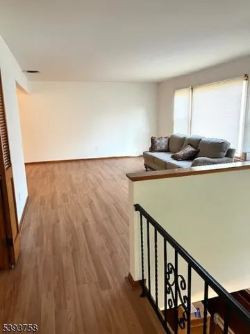 a room with wooden floor and furniture