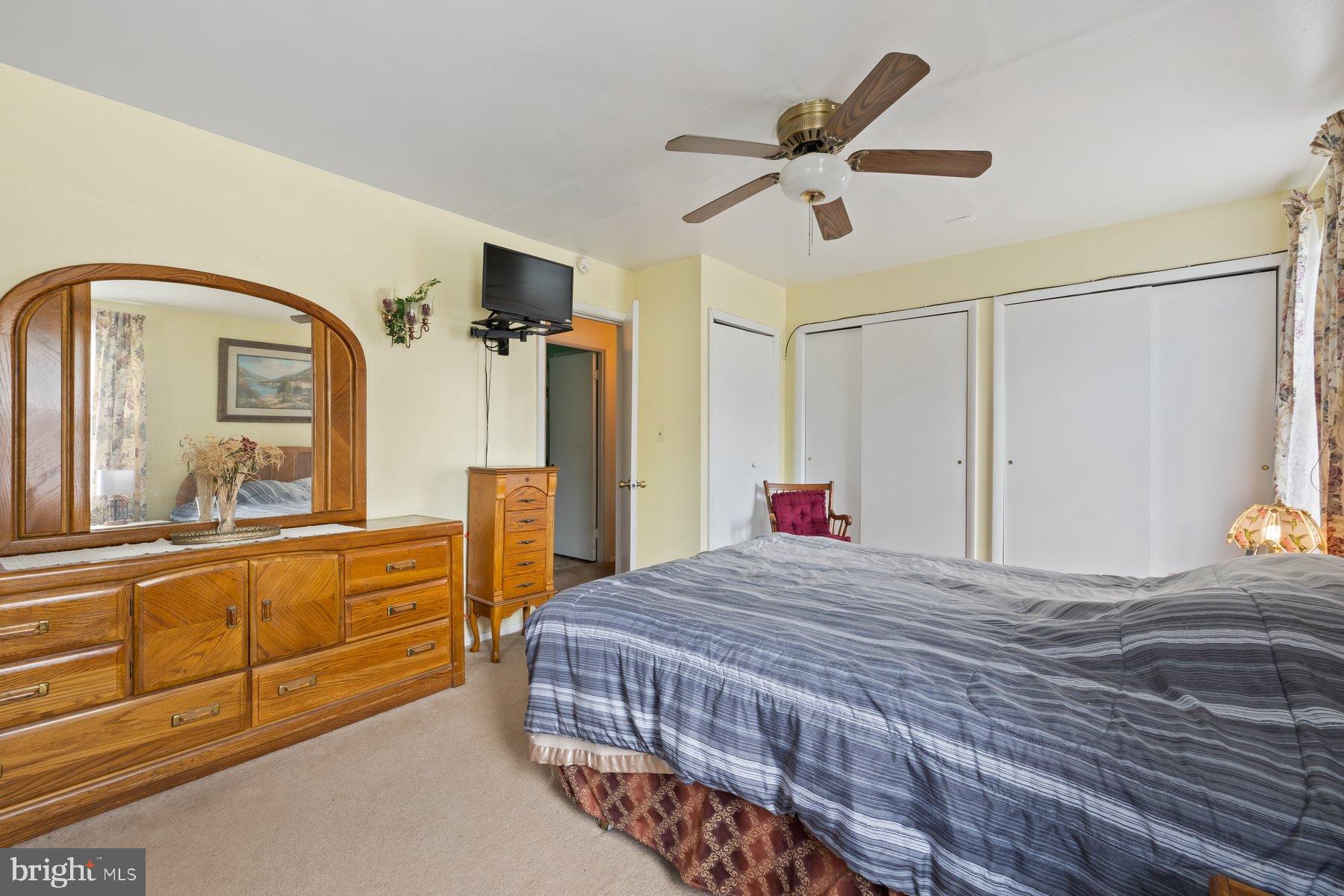488 Bruce Avenue Odenton, MD 21113 - Photo 22 of 54 a bedroom with a bed a dresser and potted plants on the dresser