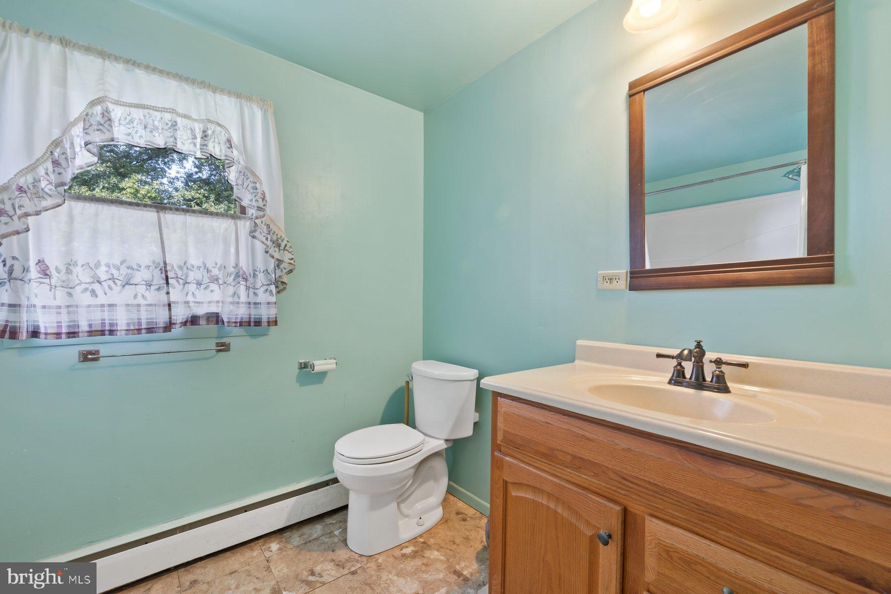 488 Bruce Avenue Odenton, MD 21113 - Photo 32 of 54 a bathroom with a toilet sink and mirror