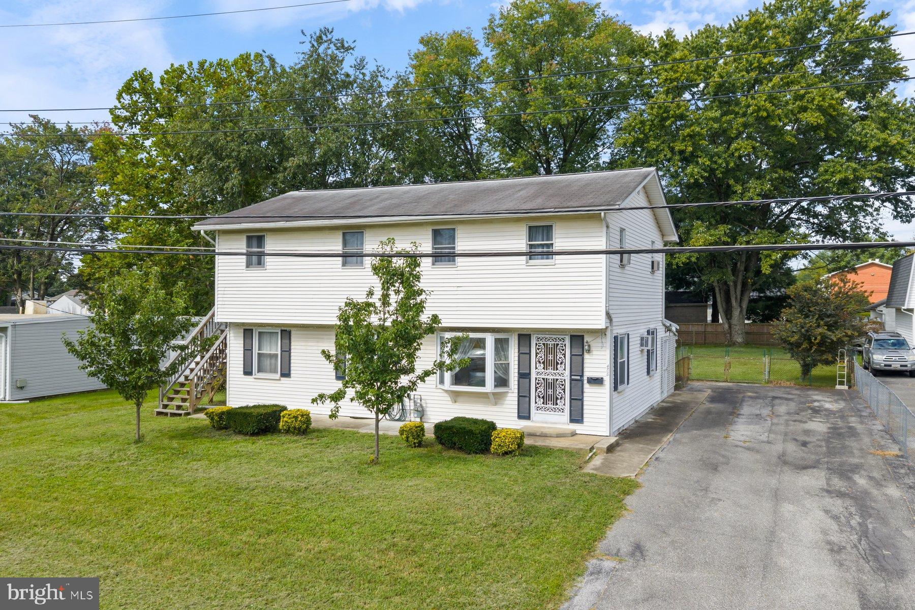 488 Bruce Avenue Odenton, MD 21113 - Photo 4 of 54 a view of a house with a yard potted plants and a large tree