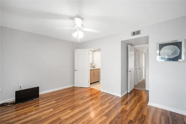 a view of a livingroom with wooden floor and closet