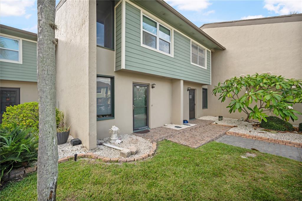 1028 Apollo Beach Boulevard, Unit 17 Apollo Beach, FL 33572 - Photo 2 of 27 a front view of a house with garden