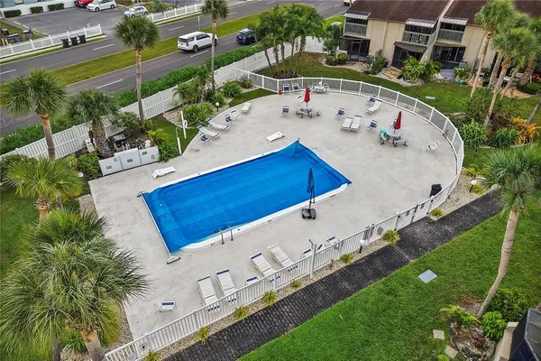 an aerial view of a house with a garden and swimming pool