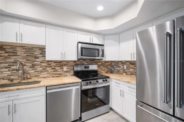 a kitchen with a sink stove and refrigerator