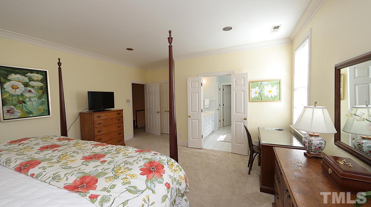 321 Marlowe Road Raleigh, NC 27609 - Photo 11 of 21 a bedroom with a bed and a flat screen tv