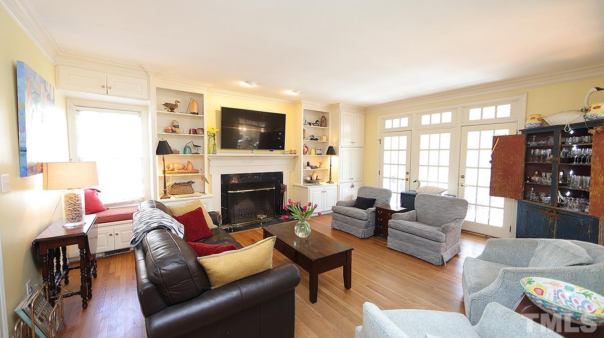 321 Marlowe Road Raleigh, NC 27609 - Photo 5 of 21 a living room with furniture a fireplace and a flat screen tv
