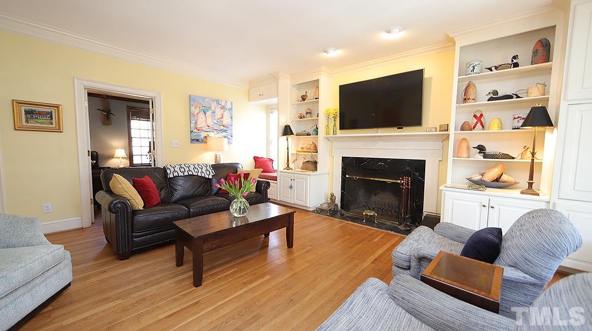 321 Marlowe Road Raleigh, NC 27609 - Photo 6 of 21 a living room with furniture a flat screen tv and a fireplace