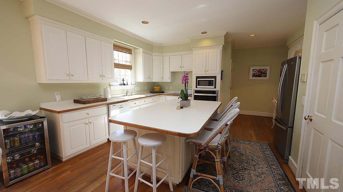 321 Marlowe Road Raleigh, NC 27609 - Photo 8 of 21 a kitchen with a table chairs sink and cabinets
