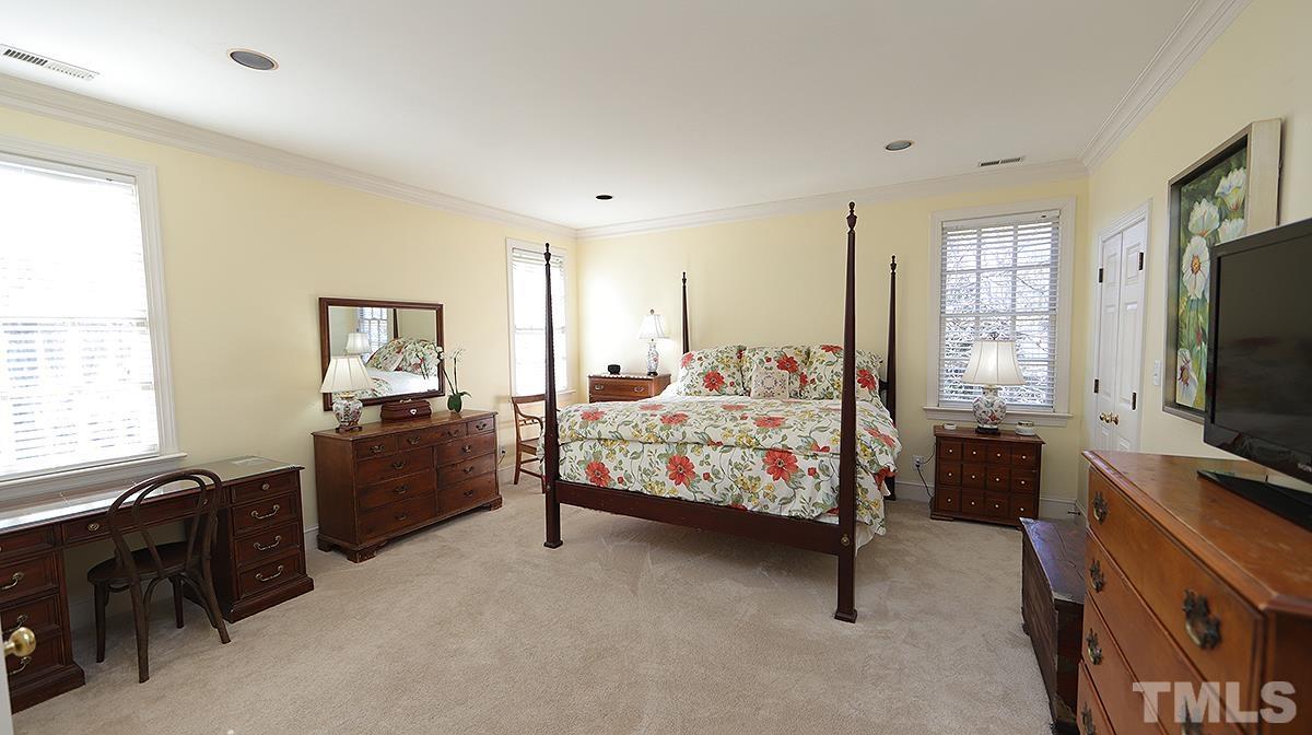 321 Marlowe Road Raleigh, NC 27609 - Photo 10 of 21 a bedroom with a bed and a flat tv screen on the dresser