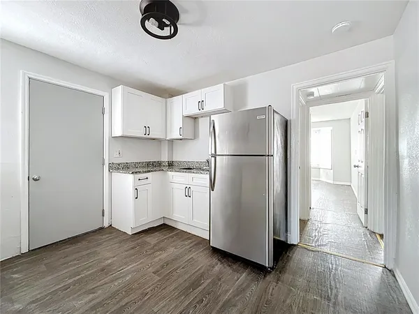a kitchen with a refrigerator and a stove top oven