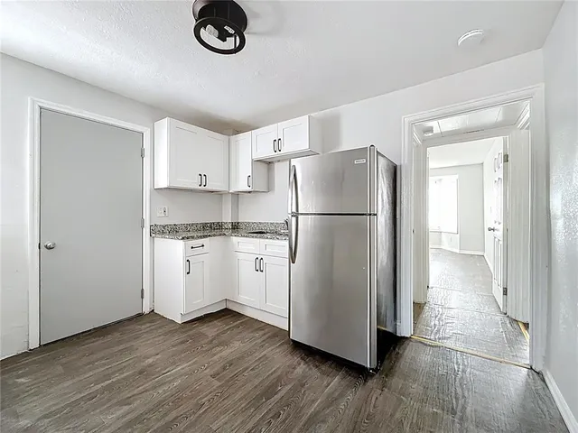 a kitchen with a refrigerator and a stove top oven