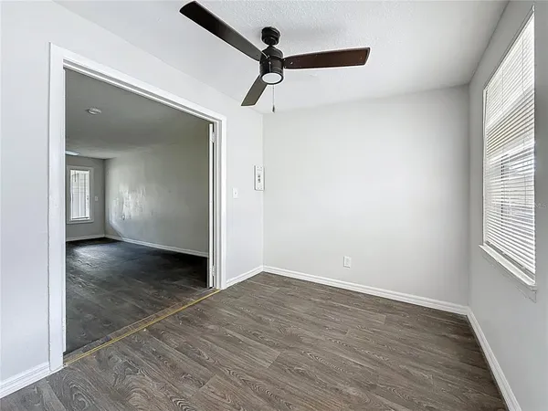 wooden floor in an empty room with a window