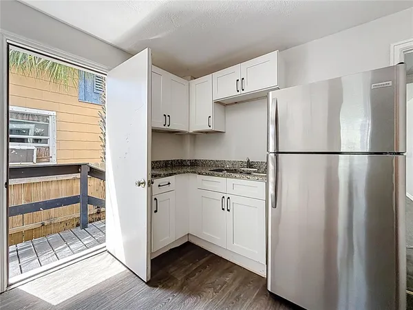 a kitchen with stainless steel appliances granite countertop a refrigerator sink and cabinets