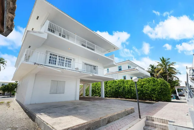 a living room with furniture potted plant and a large window