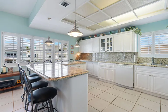 a bathroom with a toilet a sink a vanity and mirror