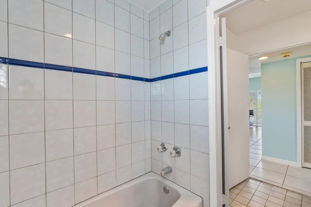 a bathroom with a sink a large mirror and shower