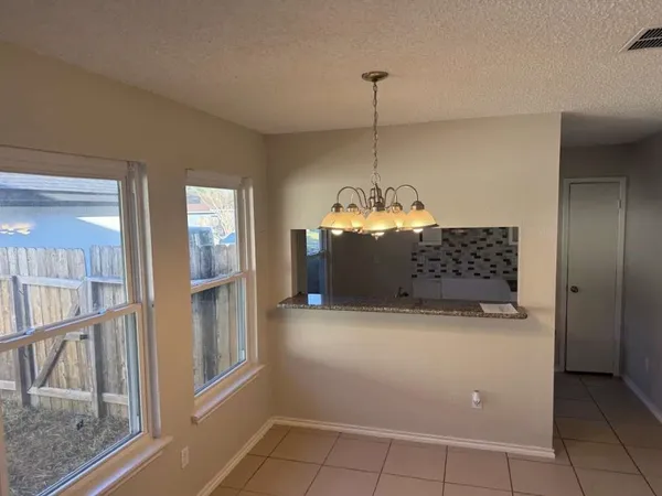 a view of a kitchen with windows and entryway