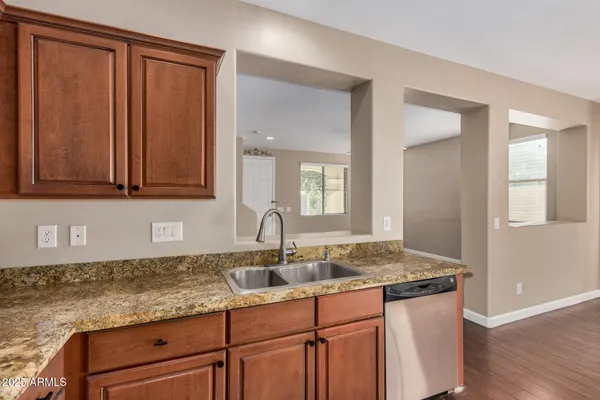 a kitchen with granite countertop a sink and cabinets