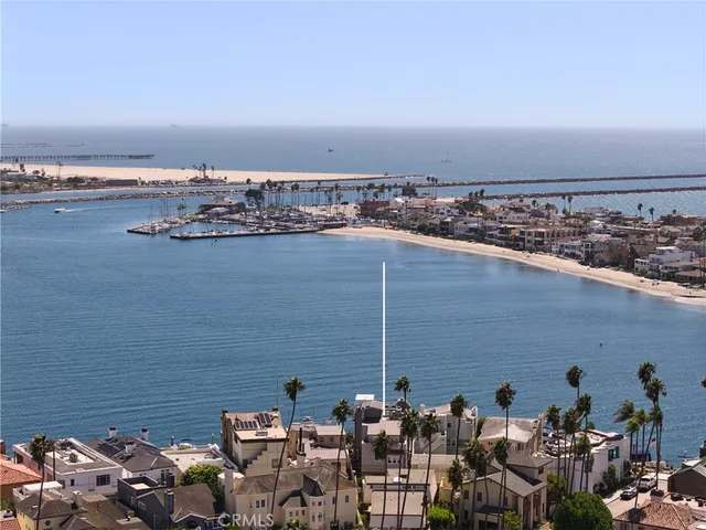 a living room with furniture a rug and kitchen view