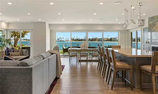 a kitchen with a dining table chairs and mirrors