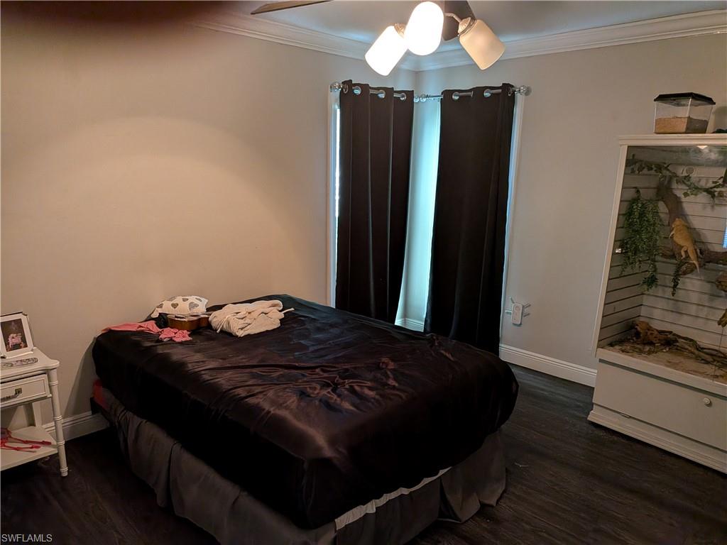 17191 Frank Road Alva, FL 33920 - Photo 9 of 27 a bedroom with a bed and a chandelier