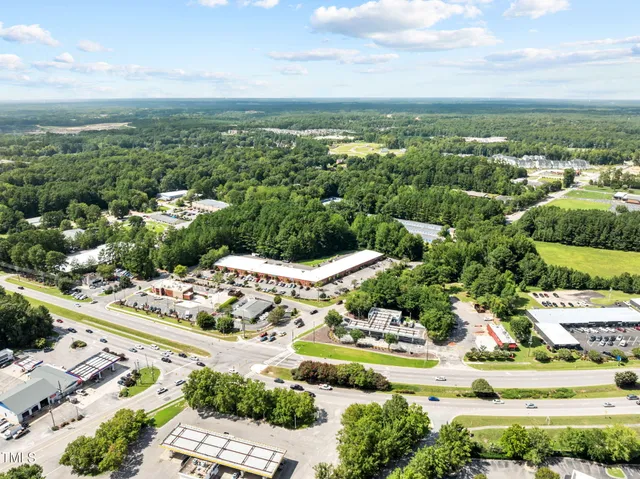 an aerial view of a house with a big yard