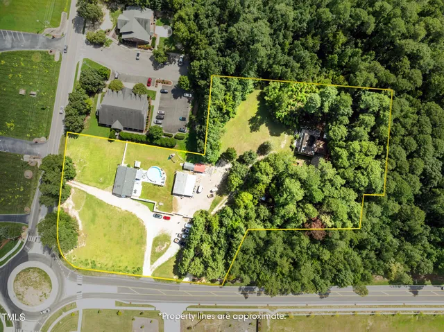 an aerial view of a house with a swimming pool