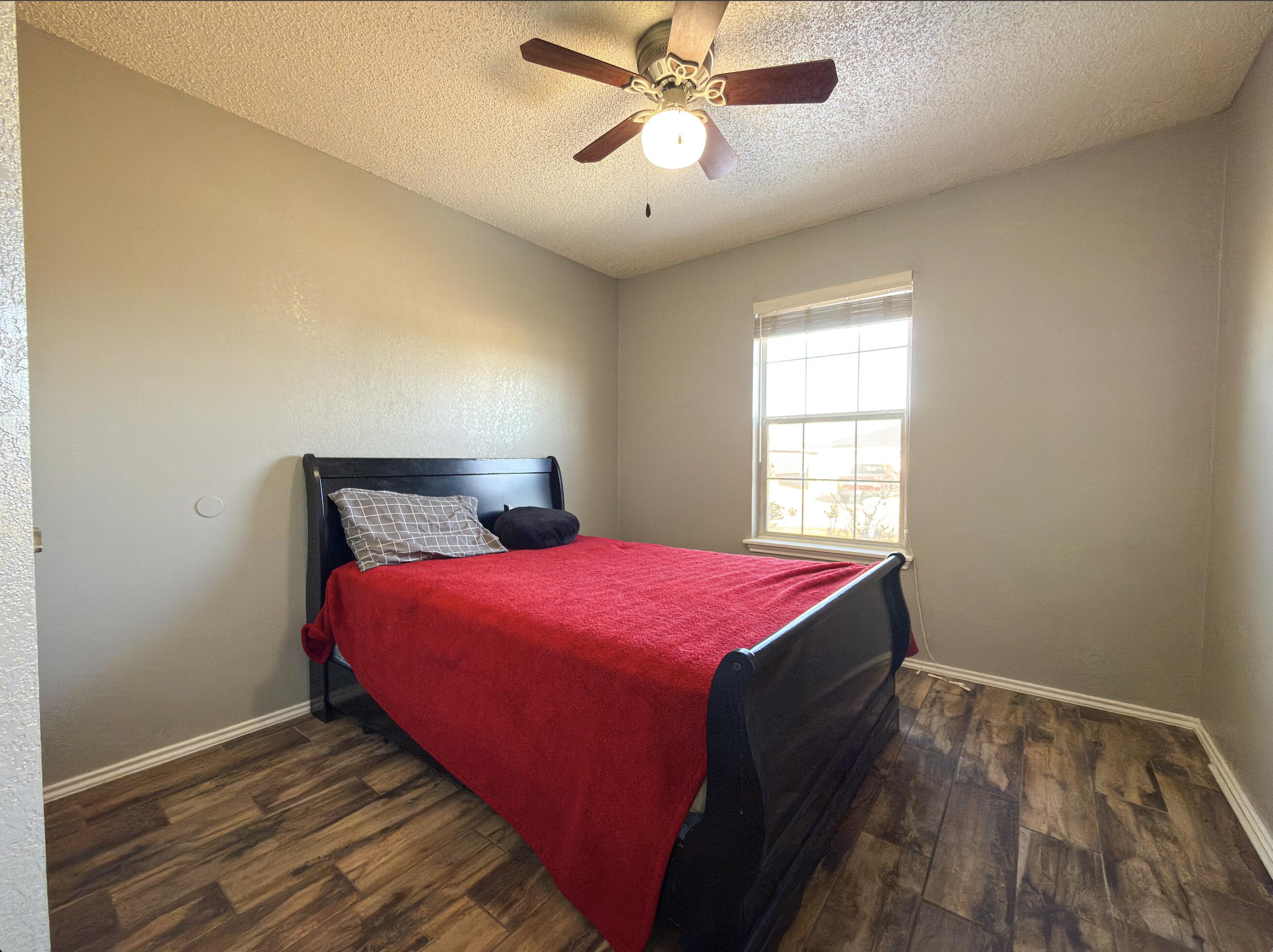 6123 39th Street Lubbock, TX 79407 - Photo 9 of 13 a bedroom with a bed and window