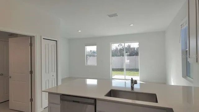 a view of a kitchen area with windows
