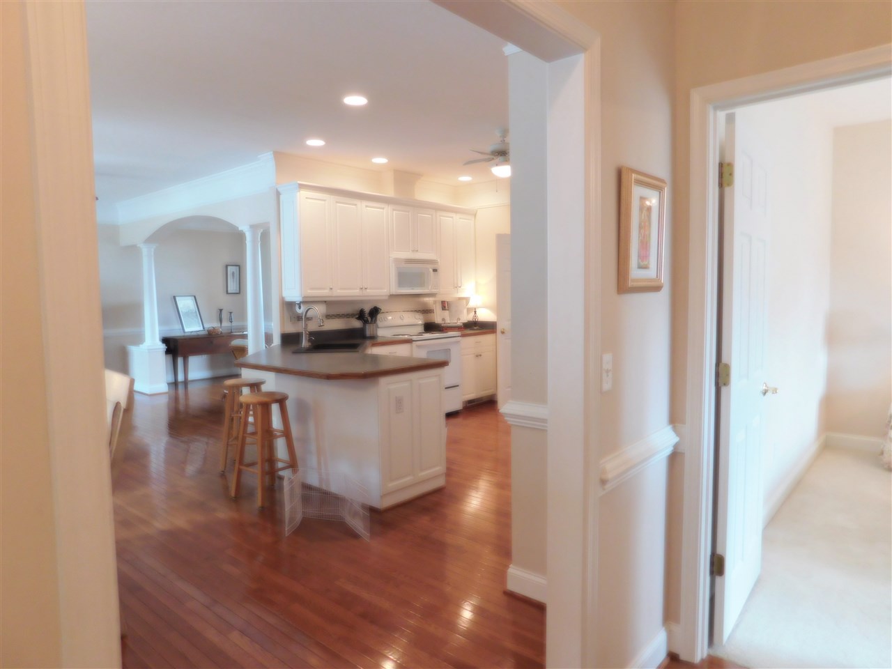 52 Hunters Trail Waynesboro, VA 22980 - Photo 26 of 32 a dining hall with stainless steel appliances kitchen island granite countertop a living room and couches with wooden floor