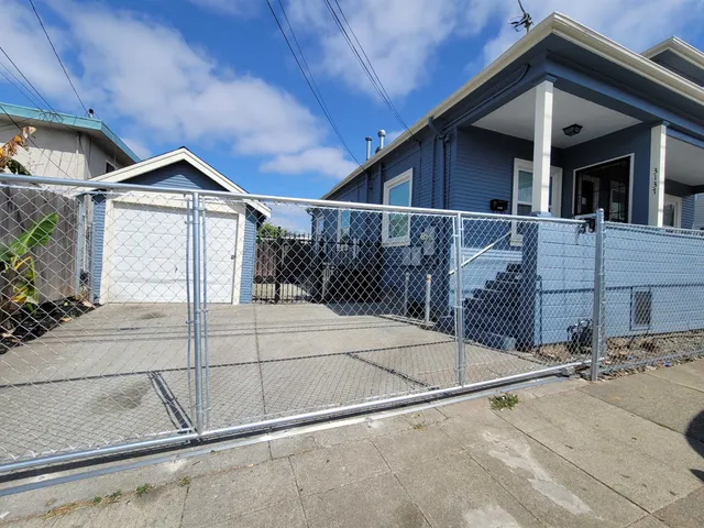 a view of a house with a wooden fence