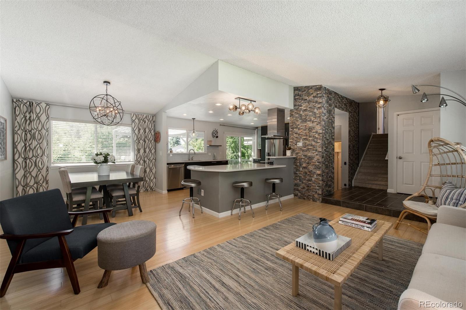 a living room with furniture and a chandelier