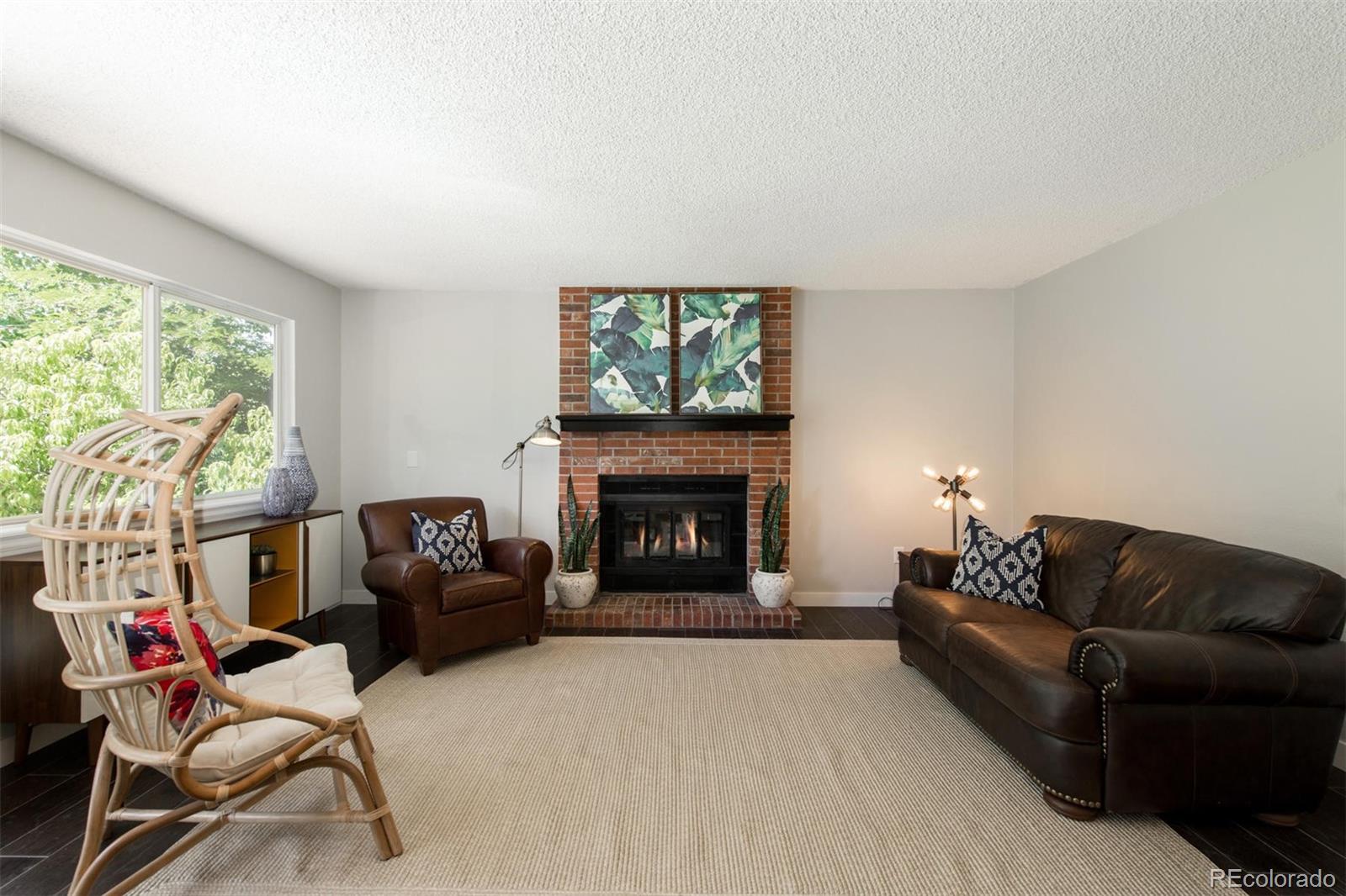 100 Prairie Ridge Road Highlands Ranch, CO 80126 - Photo 14 of 34 a living room with furniture a window and a fireplace