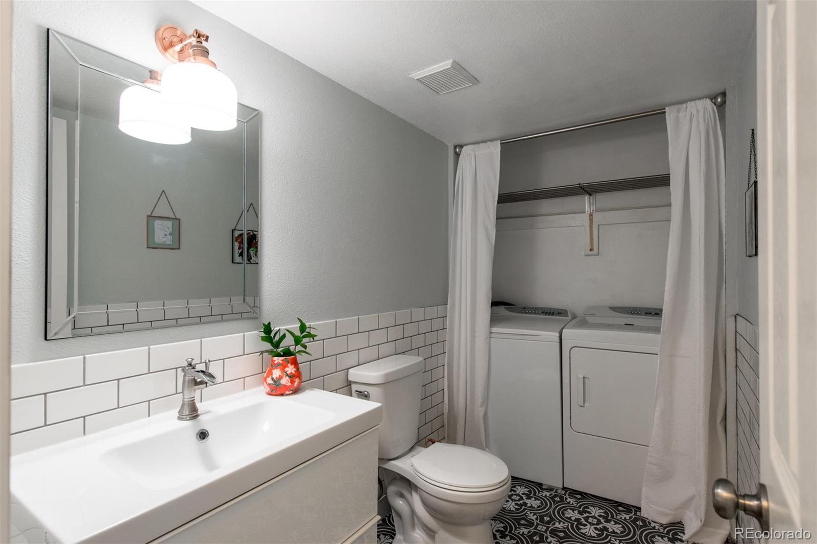 100 Prairie Ridge Road Highlands Ranch, CO 80126 - Photo 17 of 34 a bathroom with a sink a toilet and a mirror
