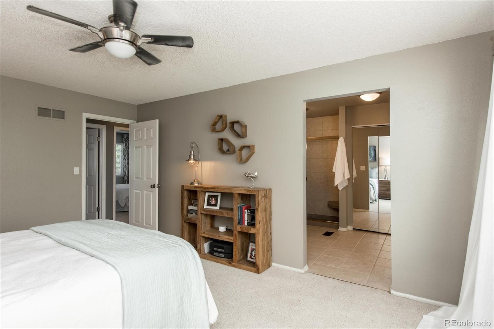 100 Prairie Ridge Road Highlands Ranch, CO 80126 - Photo 20 of 34 a bedroom with a bed and a chandelier