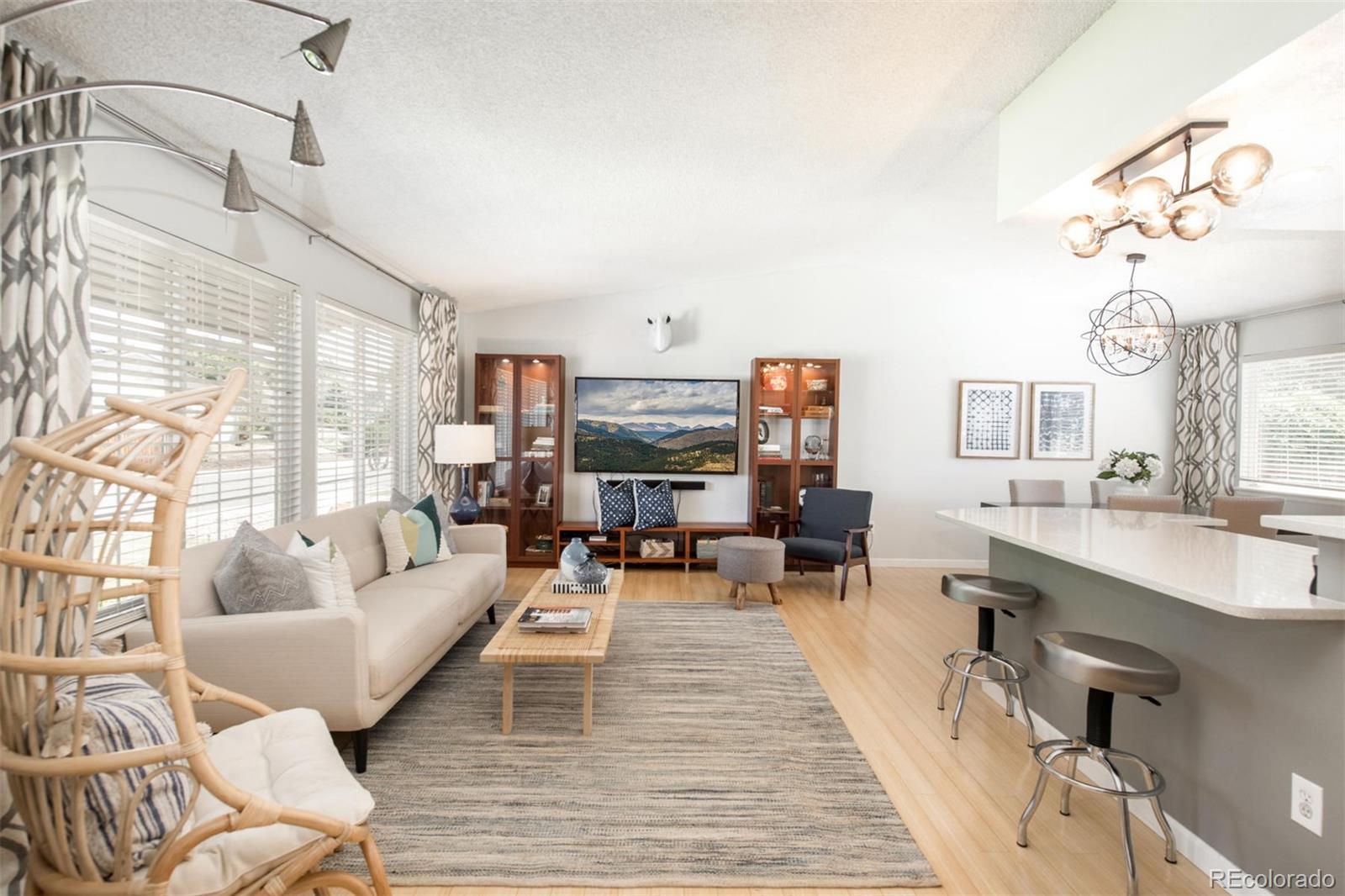 100 Prairie Ridge Road Highlands Ranch, CO 80126 - Photo 2 of 34 a living room with furniture and a wooden floor