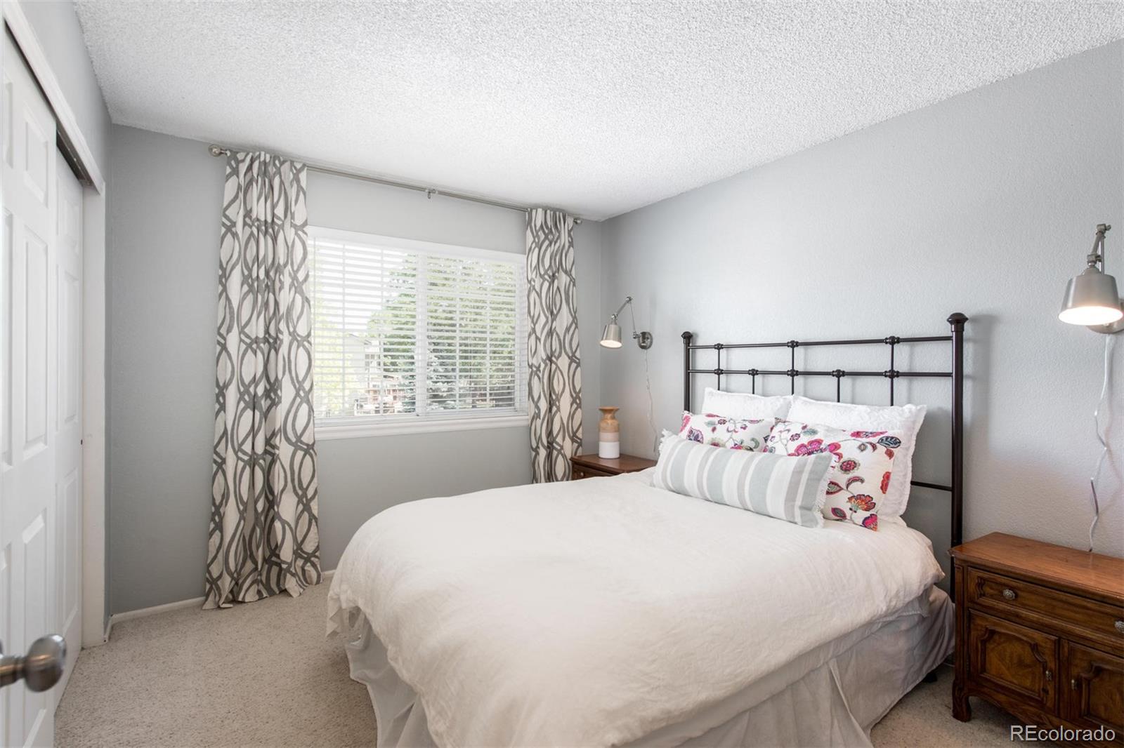 100 Prairie Ridge Road Highlands Ranch, CO 80126 - Photo 22 of 34 a bedroom with a bed and a window